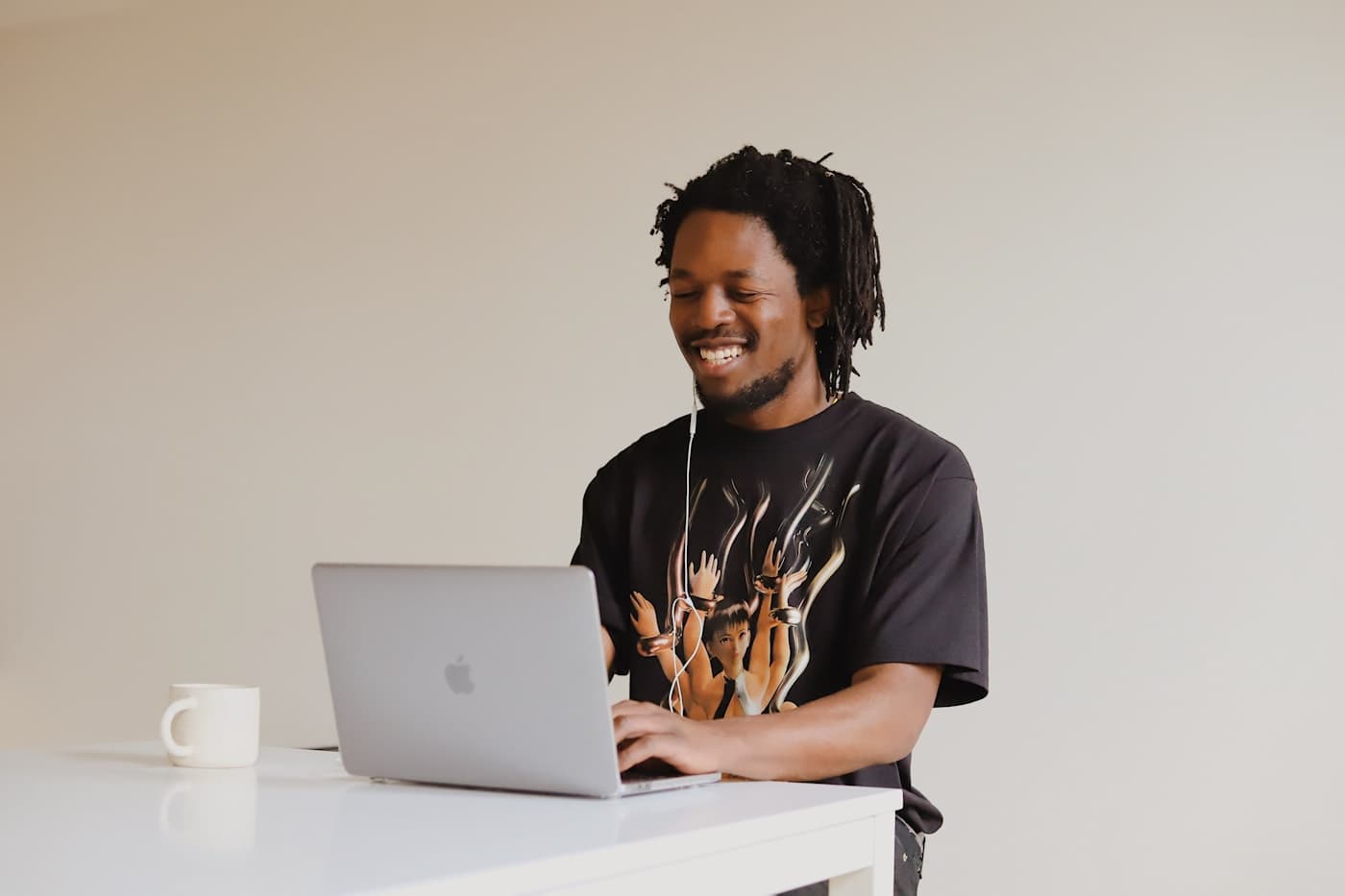 African solo founder smiling at a laptop