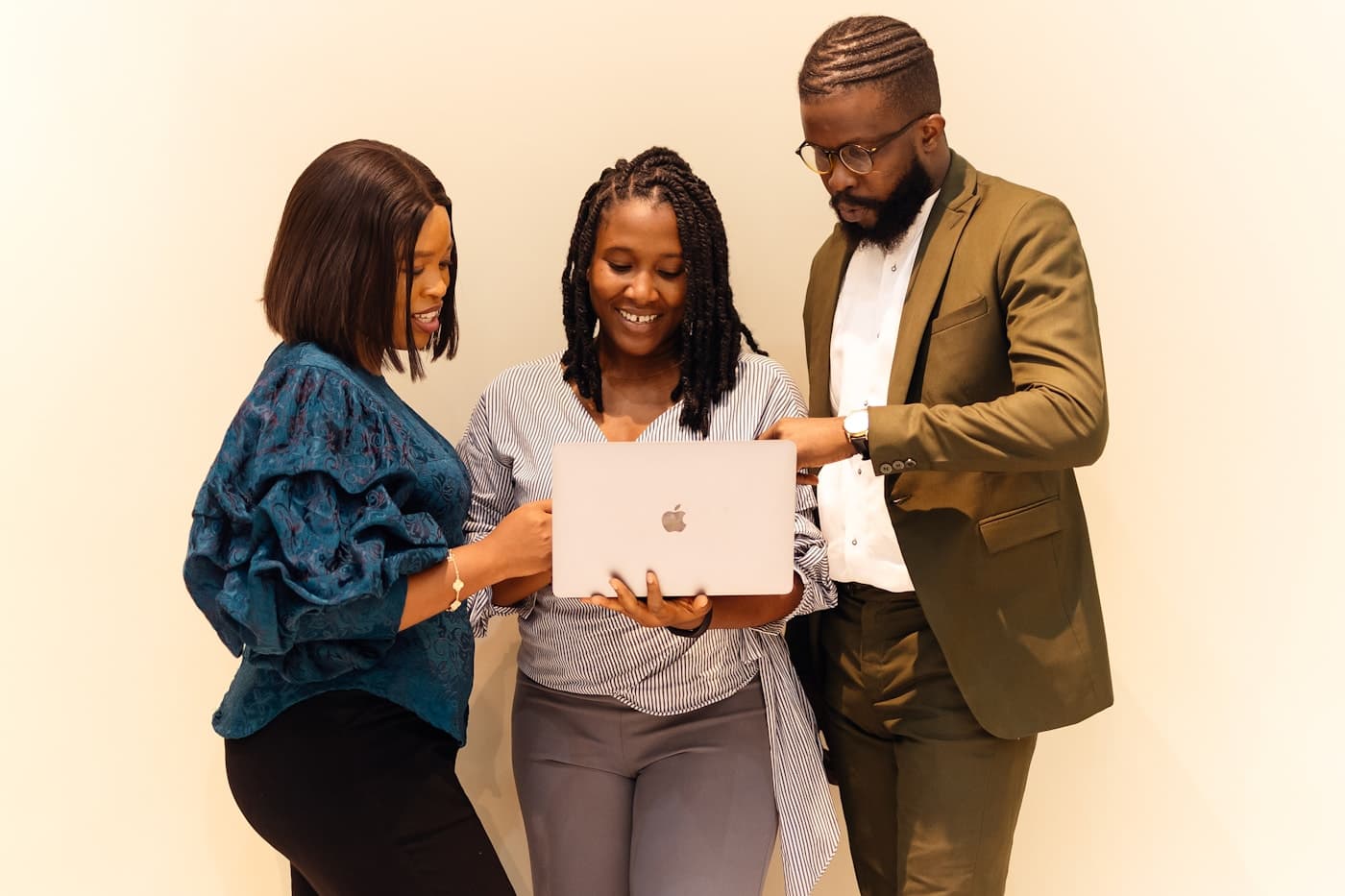African team of three gathered around one laptop